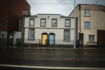 Blue and yellow door on a house in Dublin, Ireland with traditional Irish weather.