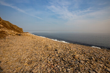 Overall plan. Winter pebble beach on Russky Island in Vladivostok. Empty rocky sea beach.