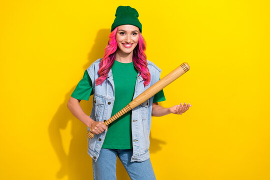 Photo of eccentric bright careless girl with pink hairdo denim waistcoat scream hold baseball bat isolated on yellow color background