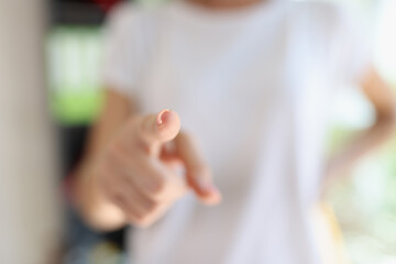 Female hand pointing at camera with finger