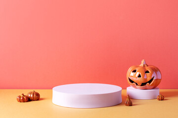 Empty product podium with Halloween pumpkin decor in pastel pink and orange colors