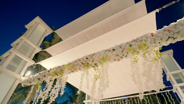 White canopy with flowers view from below. night 