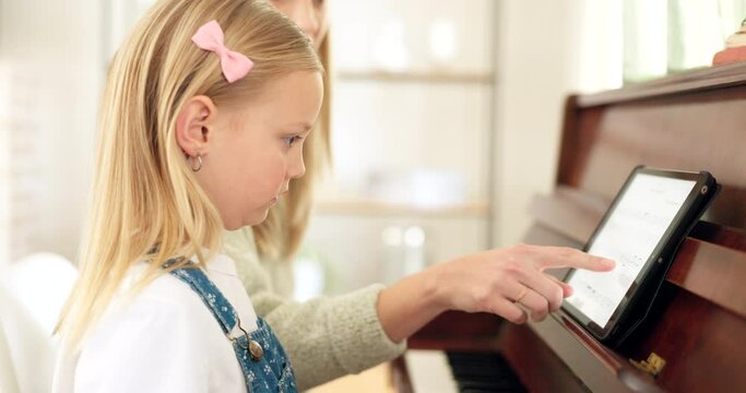 Young girl, teacher and piano with tablet, training and concentrate for lesson, instructions and practice for keys. Female student, lady pianist or instructor learning music or child art development