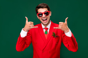 Photo of positive confident handsome guy arms fingers show shaka sign isolated on green background