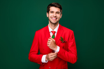 Photo of adorable pretty santa claus guy dressed red jacket preparing x-mas party isolated green color background - Powered by Adobe
