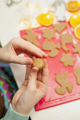 Children's hands mold Christmas cookies from gingerbread dough