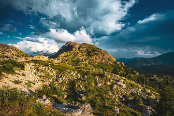 Looming thunderclouds create a beautiful evening atmosphere in the Dolomites. Falzarego pass,...