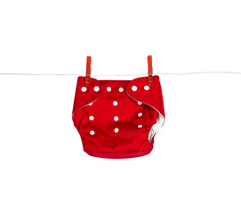 One red reusable diaper hanging on a clothesline