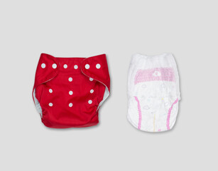 Reusable and disposable diapers on a gray background