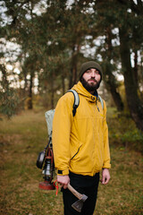 Horizontal portrait of a traveling young man surviving in the mountains with a backpack. Traveler...