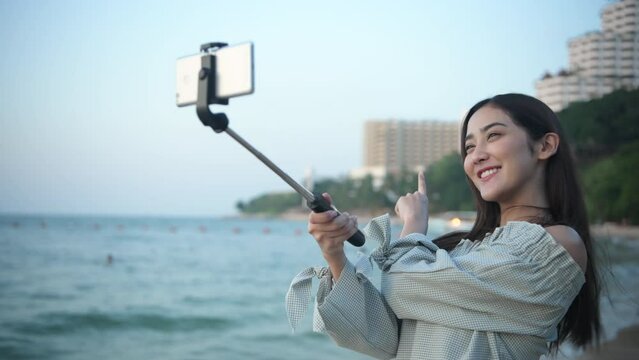 Holiday concept of 4k Resolution. Asian woman taking a selfie at the beach.