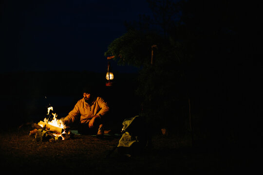A traveler cooks fried eggs on a bonfire. The concept of travel and survival in the wild.