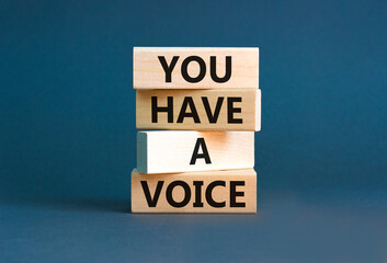 You have a voice symbol. Concept words You have a voice on wooden blocks. Beautiful grey table grey background. Business, psychological you have a voice concept. Copy space.