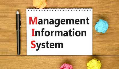 MIS management information system symbol. Concept words MIS management information system on white note on a beautiful wooden background. Business MIS management information system concept. Copy space