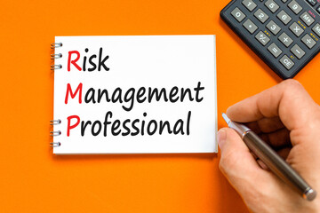 RMP risk management professional symbol. Concept words RMP risk management professional on white note on a beautiful orange background. Business RMP risk management professional concept. Copy space.