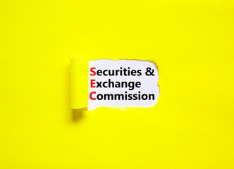 SEC securities and exchange commission symbol. Concept words SEC securities and exchange commission on white paper on a yellow background. Business SEC securities exchange commission concept.