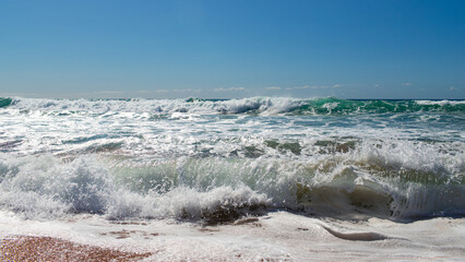 Wave breaking on the beach shore.