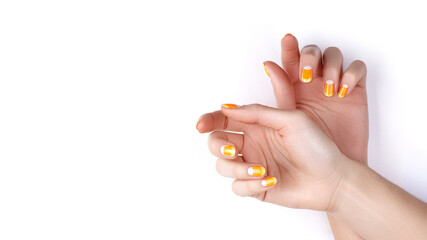 Beautiful Female Hands with bright orange Manicure like Candy Corn. Manicured Nails with Yellow Gel Polish. Halloween Style