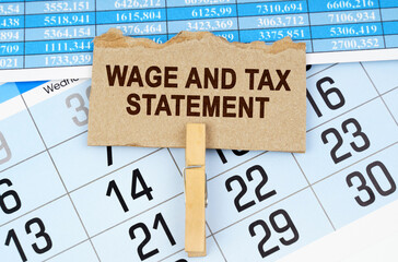 On the calendar and reporting documents is a cardboard plate with the inscription - Wage and Tax Statement