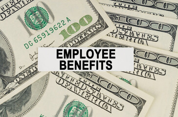 On the dollars lies a paper plate with the inscription - Employee benefits