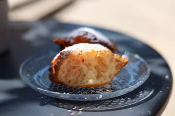 Ruchanki - traditional dessert baked from bread dough, hot fried on fat, topped with powdered sugar, Kashubia, Poland