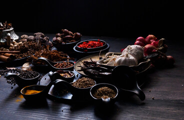 Top view photo Lots of garlic, onions, peppers, chili and dried herbs, were placed on plates and...