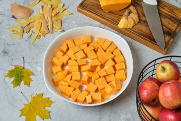 Pumpkin slices ready for baking, an ingredient for autumn dishes. Comfort food.