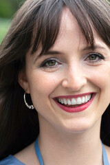 Portrait of attractive woman smiling at camera outdoors