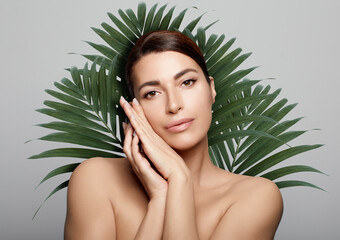 Beauty spa woman against fresh green exotic palm background. Skin care beauty treatments concept.