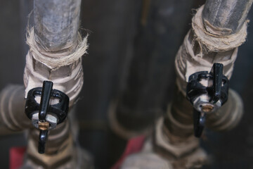 Black brass ball shut-off valves on water supply pipeline in the house, plumbing and construction...