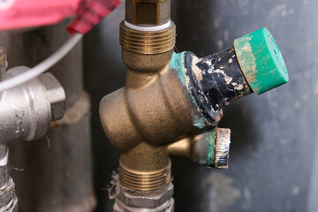 Worn woter supply equipment, leaking corroded water flow regulator, reducer, plumbing repair concept
