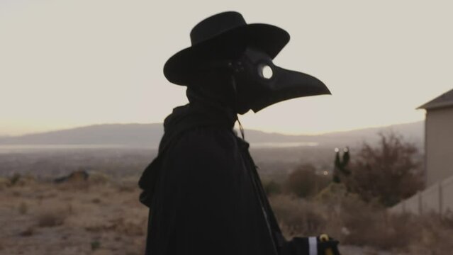 Tracking shot of person walking wearing plague doctor costume / Cedar Hills, Utah, United States