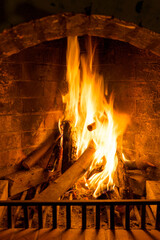 Burning woods in a brick fireplace