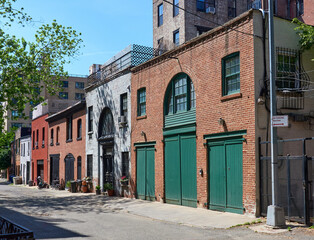 Old brick stables in Hunts Lane in Brooklyn Heights, NYC. These buildings are now garages or...