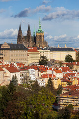 Obraz premium Autumn Prague City with gothic Castle, colorful Nature and Trees and dramatic Sky from the Hill Petrin, Czech Republic
