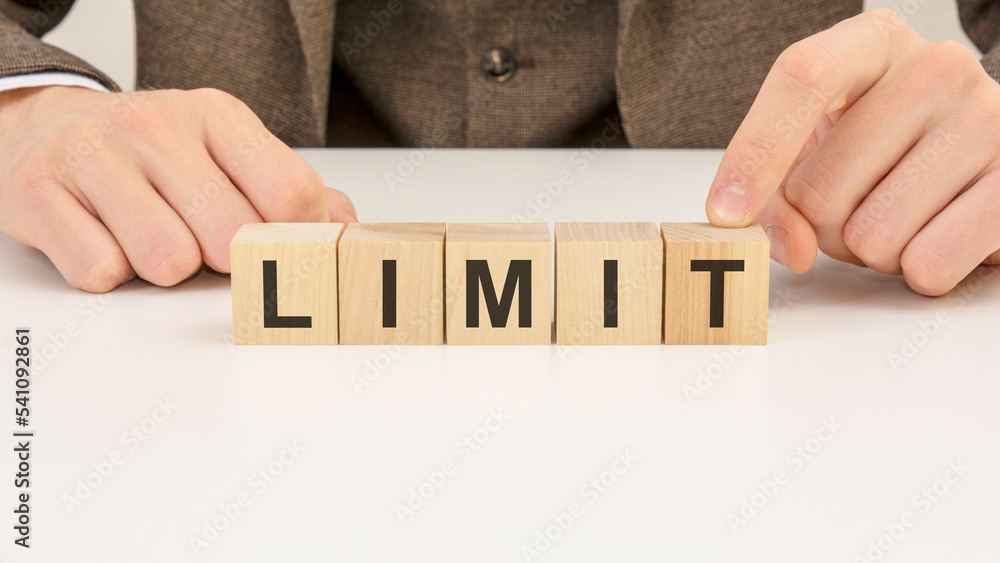 Poster man made word limit with wooden blocks