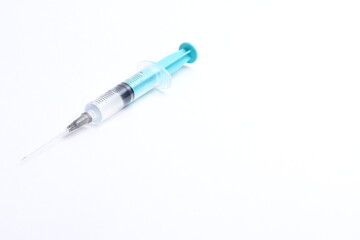 Fototapeta premium Medical syringe on a white background. A syringe for injection. The concept of health and beauty
