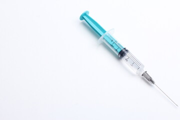 Fototapeta premium Medical syringe on a white background. A syringe for injection. The concept of health and beauty