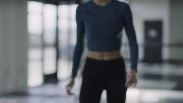 Woman using cell phone recording video of herself dancing in dance studio / Lehi, Utah, United States