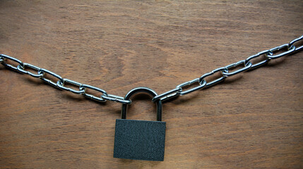 Fototapeta na wymiar Key lock locked with a chain on table .