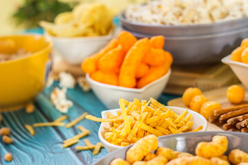 Beer salty snacks on wooden table