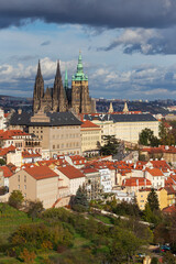 Autumn Prague City with gothic Castle, colorful Nature and Trees and dramatic Sky from the Hill Petrin, Czech Republic