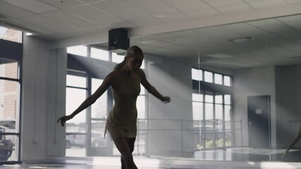 Woman practicing contemporary dancing on floor in dance studio / Lehi, Utah, United States