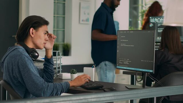 System engineer working with html script on terminal window, looking at computer screen and typing. Software developer in it office writing innovating ai algorithm and system programming.