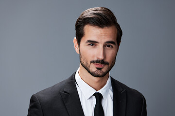 Portrait of a business man with a natural smile on a gray background in a business suit. Business portrait of a stylish man