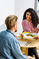 Fototapeta premium Young and beautiful woman smiling, sitting in the chair in a restaurant.