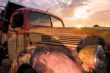 Old rusty truck at sunset