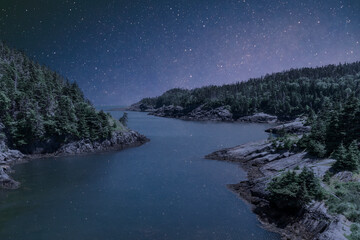 A starry night hovers over the darkness in the ghost town of La Manche, Newfoundland. © John