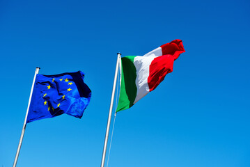 European and Italian flag in the blue sky