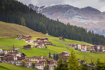 Fototapeta na wymiar Tux village cityscape above Zillertal valley, Tyrol Snowcapped alps, Austria